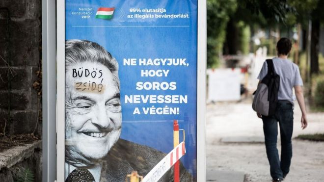 A poster showing George Soros, on which someone has written "dirty Jew"