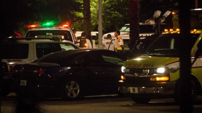 Police officers and emergency teams search for a child