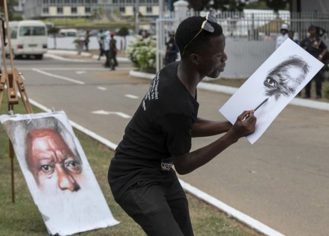 Уличный художник рисует портрет Кофи Аннана на месте после государственных похорон в Аккрском международном конференц-центре, Гана, 13 сентября 2018 года.