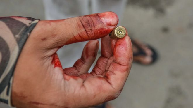 A protester holds a bullet fired during a protest against the military coup in March 2021