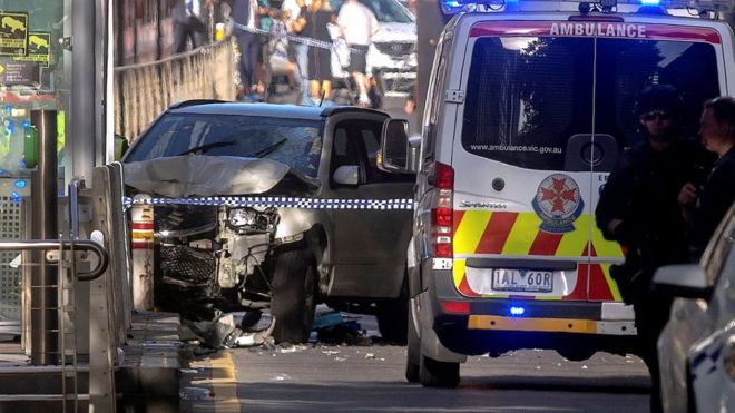 Австралийская полиция стоит возле разбившегося транспортного средства, которое врезалось в пешеходов возле железнодорожного вокзала Флиндерс-стрит в центре Мельбурна, Австралия, 21 декабря 2017 года