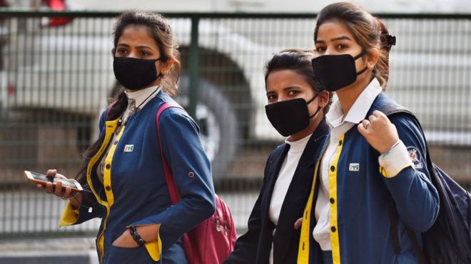 Students wearing protective masks as a precautionary measure following multiple positive cases of Coronavirus in the country