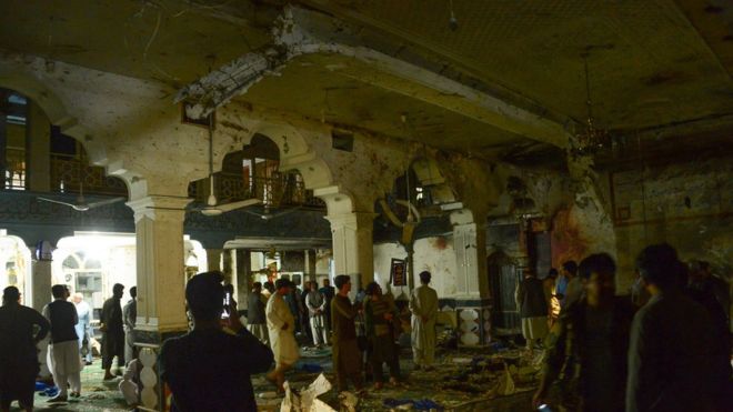 Afghan security personnel inspect the site of a suicide bomb attack at a Shiite mosque in Herat on August 1, 2017.