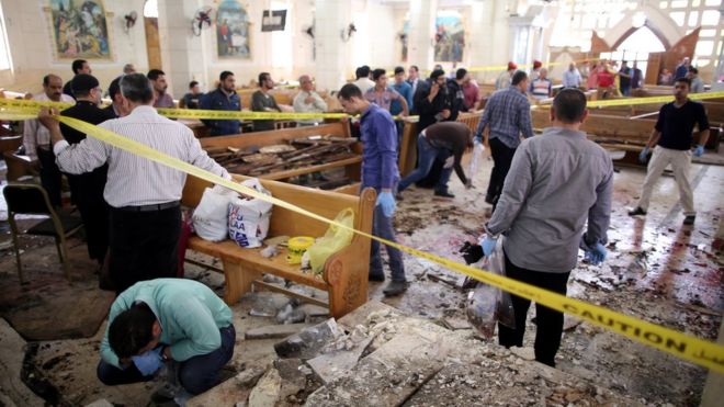 Security personnel investigate the scene of a bomb explosion inside Mar Girgis church in Tanta