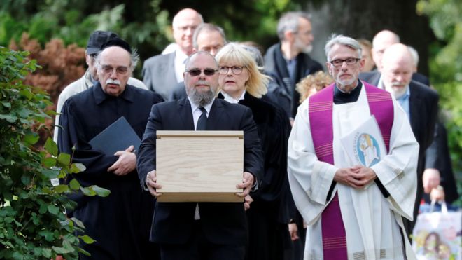 Mourners with coffin containing victims' tissue, 13 May 19
