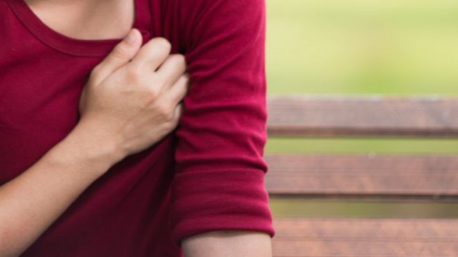 Woman holds chest