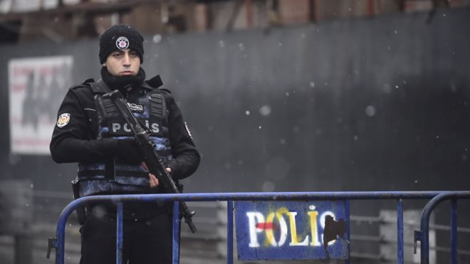 A Turkish police officer stands guard close to the site of an armed attack near the Reina night club on 1 January 2017