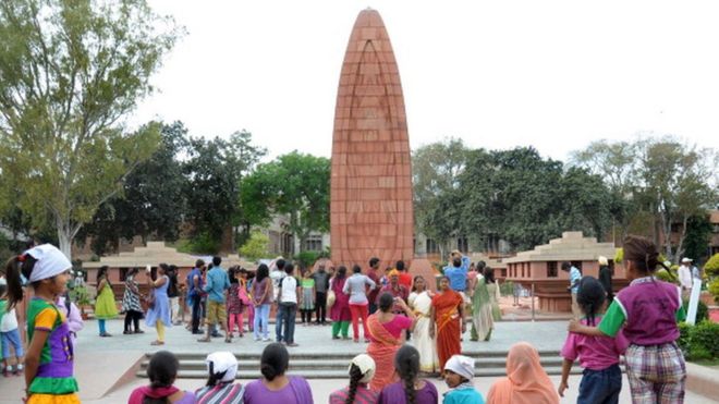 Indian visitors gather near the Jallianwala Bagh Martyrs' Memorial in Amritsar
