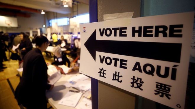 An arrow sign reading 'Vote Here' pictured at a primary school polling station in Manhattan, New York.