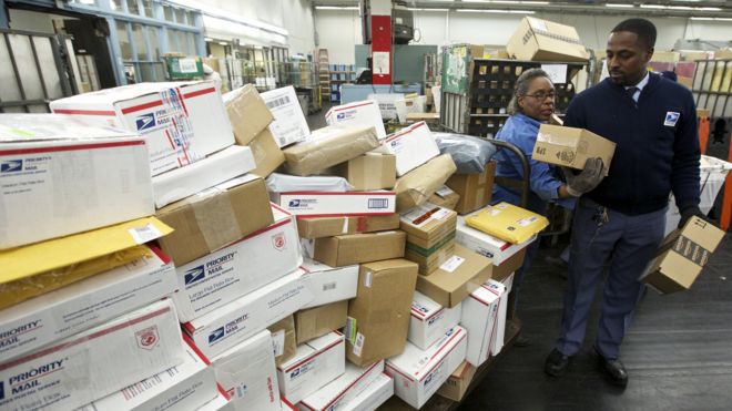 A United States Postal Service employee sorts packages in Chicago in 2012.