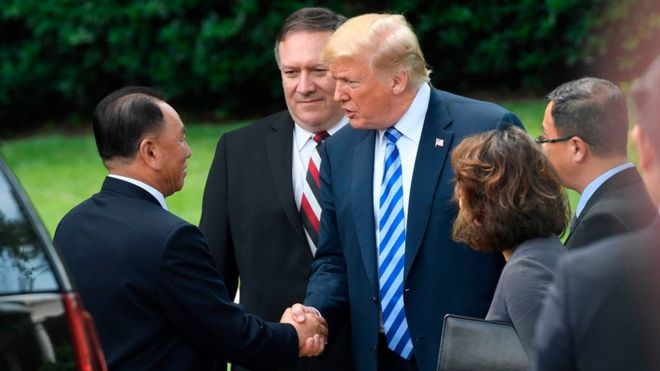 US President Donald Trump (C-R), flanked by US Secretary of State Mike Pompeo shakes hands with North Korean Kim Yong Chol