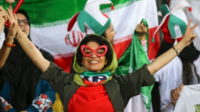 An Iranian woman cheers during the World Cup Qatar 2022 Group C qualification football match between Iran and Cambodia at the Azadi stadium in the capital Tehran on 10 October 2019.