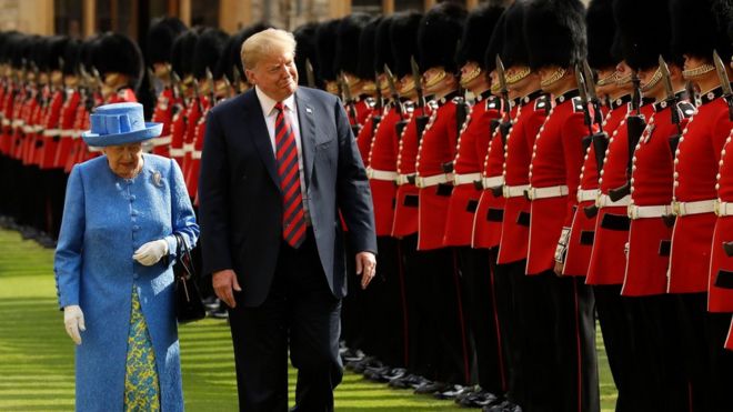 The Queen walks alongsidDonald Trump as the US President inspects the guard of honour during a welcome ceremony at Windsor Castle on 13 July 2018