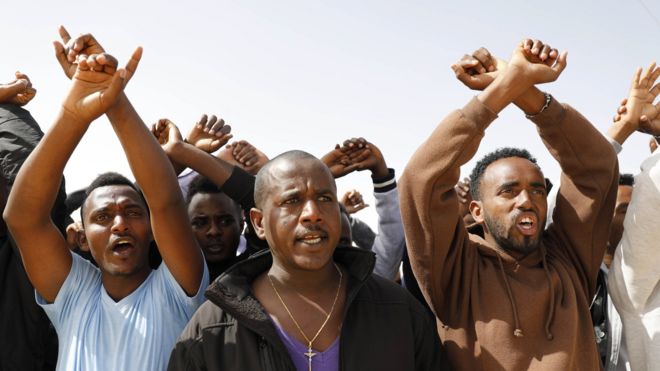 African asylum seekers protest against the detention of 18 asylum seekers who were imprisoned after refusing to leave the country, outside Holot detention facility near the Israeli-Egyptian border in southern Israel, 22 February 2018