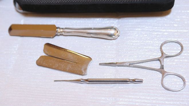 Instruments used in the Jewish circumcision ceremony lie on a table prior to the circumcision of baby infant