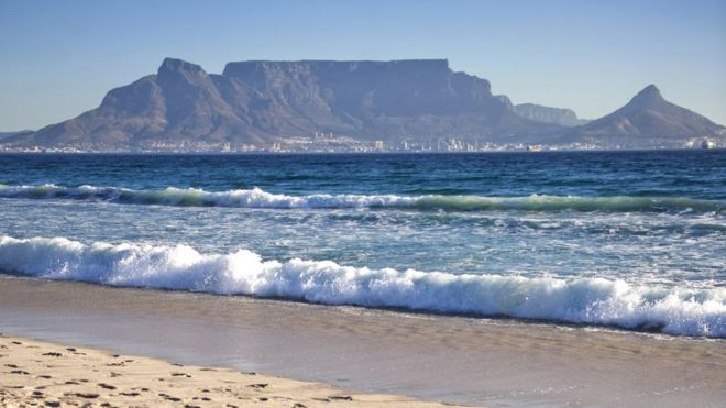 Общий вид на Столовую гору и город Кейптаун виден 2 апреля 2010 года с пляжа Блуберг на окраине Кейптауна.