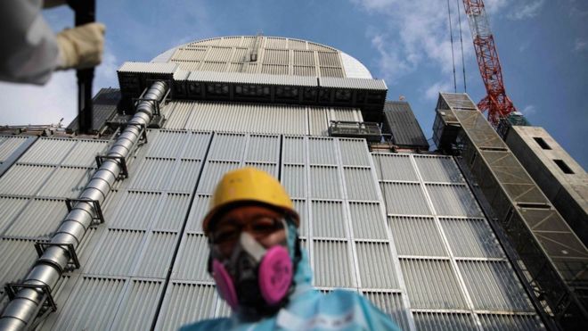 Tepco employee in front of the reactor three at Fukushima Daiichi nuclear power plant in Okuma, Fukushima prefecture, 31 Jan 2018