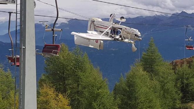 A plane left dangling in the Italian Alps