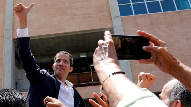 Venezuelan opposition leader Juan GuaidÃ³ greets supporters after his arrival at the Simon Bolivar International airport in Caracas, Venezuela March 4, 2019