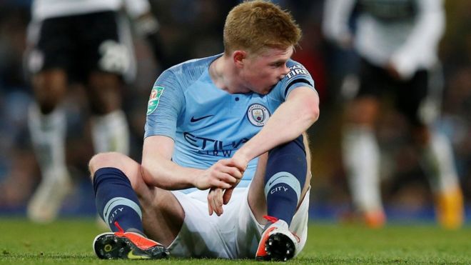Kevin de Bruyne sits on the turf after his injury