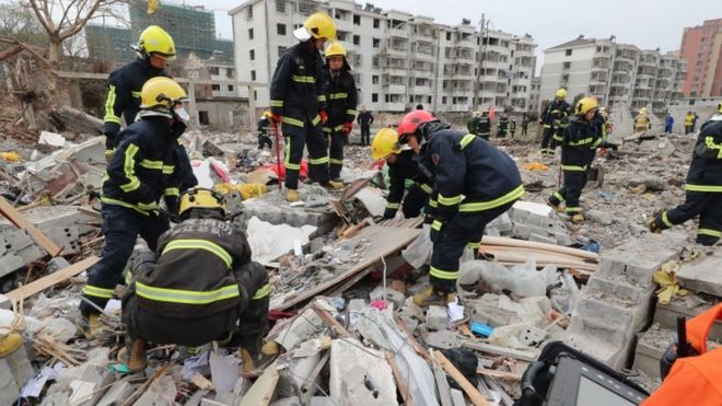 Rescue workers look for survivors after an explosion in Ningbo, China