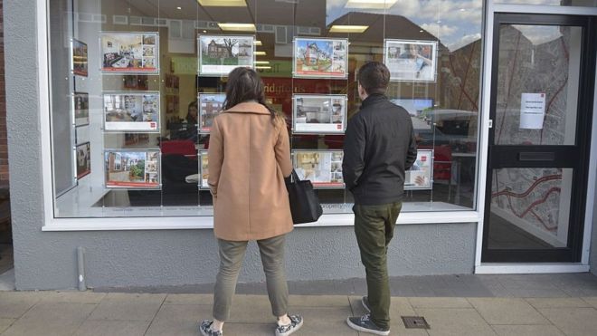 two people looking into estate agents