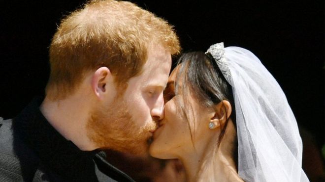 Prince Harry and Meghan Markle kiss on the steps of St George's Chapel in Windsor Castle