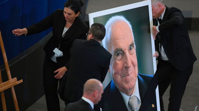 Officials install a portrait of Mr Kohl at the European Parliament