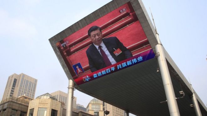 A large screen displays Chinese President Xi Jinping attending the closing session of the National People's Congress (NPC), in Beijing, China, 11 March 2021