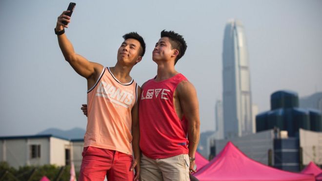 A couple take a 'selfie' at Pink Dot, a lesbian, gay, bisexual, transgender/transsexual and intersex (LGBTI) carnival in the West Kowloon district of Hong Kong on September 25, 2016. Pink Dot, 2016, is a free carnival co-organised by BigLove Alliance and Pink Alliance for friends, family and colleagues of the LGBTI community that celebrates inclusivity and diversity.