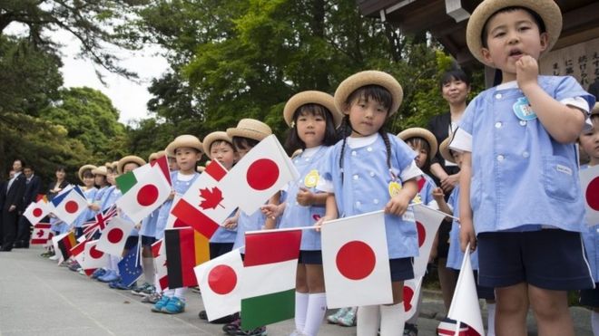 A group of school children wait for the G-7 leaders to arrive for their tour of the Ise Jingu shrine in Ise, Japan, Thursday, May 26, 2016.
