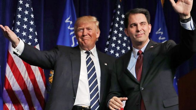 Republican presidential nominee Donald Trump (L) is welcomed to the stage by Wisconsin Governor Scott Walker during a campaign rally at the W.L. Zorn Arena November 1, 2016 in Altoona, Wisconsin.