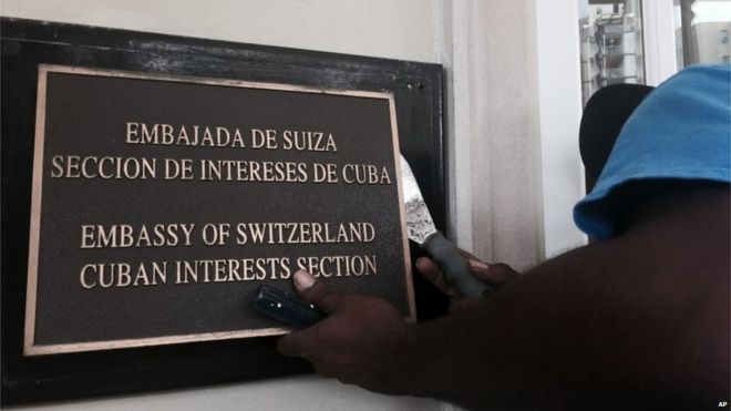 Рабочий убирает табличку Кубинского отдела интересов в Вашингтоне, за несколько дней до того, как здание будет аккредитовано в качестве посольства Кубы (15/07/2015)