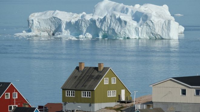 An iceberg near a village in Greenland