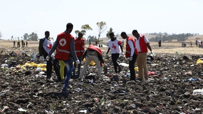 Работа команды Красного Креста на фоне обломков на месте крушения авиакомпании Эфиопии