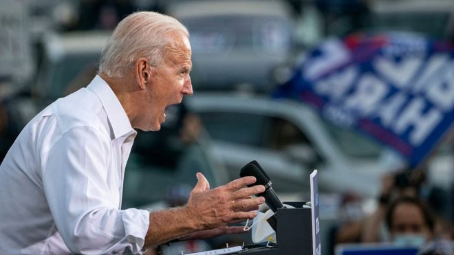 Joe Biden speaks during a drive-in campaign rally in the parking lot of Cellairis Amphitheatre on October 27, 2020 in Atlanta, Georgia