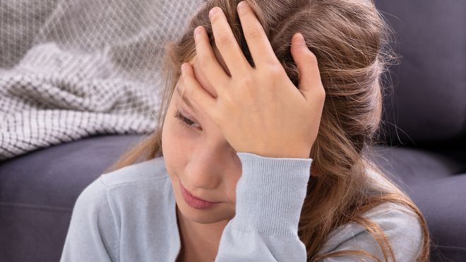 Stock image of a child with a headache