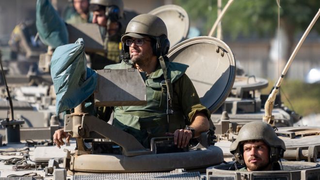 IDF Soldiers ride in armored personnel carriers