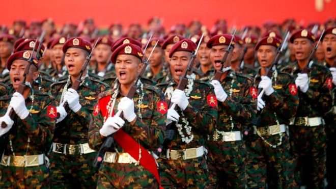 Myanmar soldiers march in formation during a military parade in Nay pyi daw on March 27, 2018