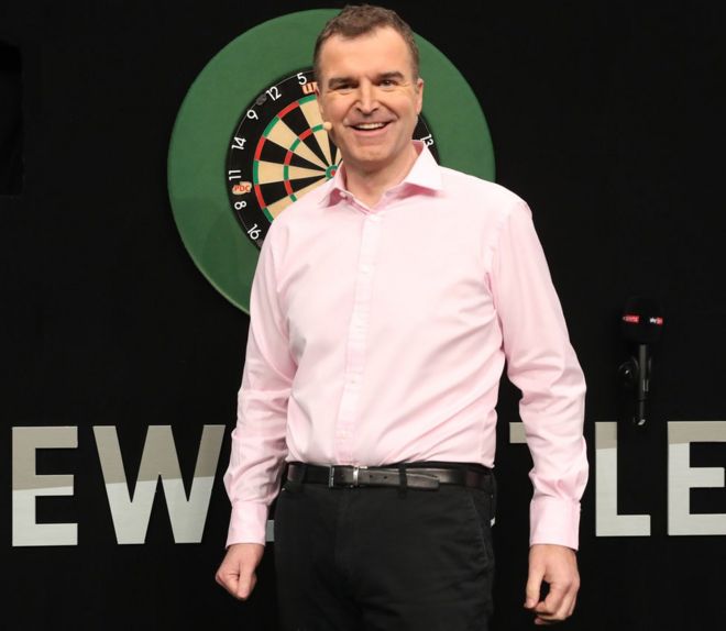 Dave Clark in front of a dart board in Newcastle