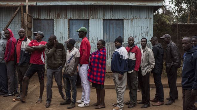 Люди собираются, чтобы проголосовать в Олимпийской начальной школе в Кибере, одной из самых больших трущоб в Африке, 8 августа 2017 года в Найроби, Кения. Кенийцы направляются на избирательные участки, чтобы принять участие в выборах, в которых участвуют президенты Ухуру Кеньятта и его соперник Раила Одинга.