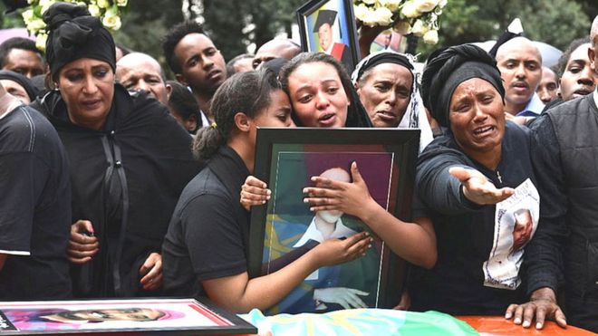 Relatives mourn next to the coffins of Ethiopian passengers and crew members, during a memorial service for the victims of the Ethiopian Airlines Flight ET 302 plane crash, at the Selassie Church in Addis Ababa, Ethiopia March 17, 2019.