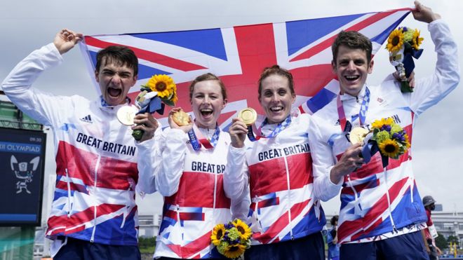 Great Britain celebrate winning the inaugural triathlon mixed relay event at an Olympic Games