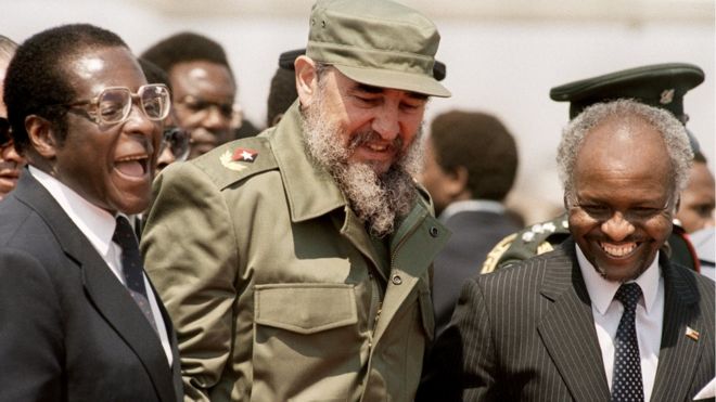 Cuban President Fidel Castro (C) shares a laugh with Zimbabwean President Canaan Banana (R) and Zimbabwean Prime minister Robert Mugabe (L) as he arrives in Harare, Zimbabwe - 31 August 1986