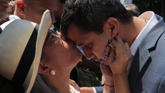 Председатель Национальной ассамблеи Хуан Гуайдо (R) целуется с матерью Норкой Маркес перед выступлением перед демонстрантами, которые выступили против президента Николаса Мадуро в Каракасе, Венесуэла, 2 февраля 2019 года