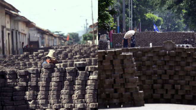 A man crouches behind a barricade and points a rifle in 1979/ Local residents walk between barricades in Masaya, some 35km from Managua on June 20, 2018.
