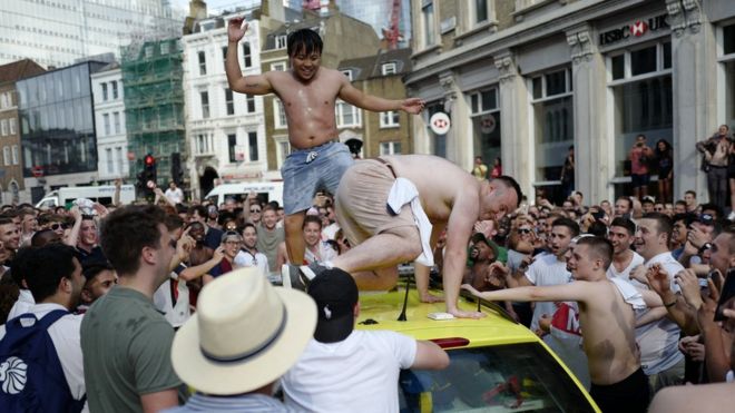 England fans celebrating damaged ambulance