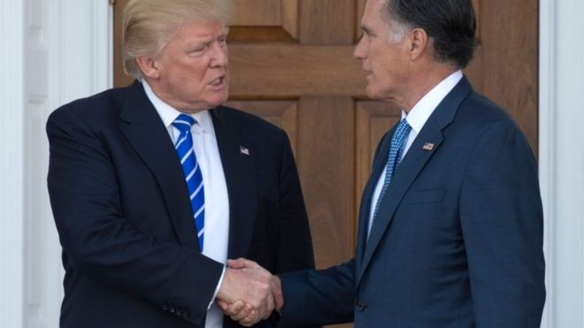 Donald Trump shakes hands with Mitt Romney