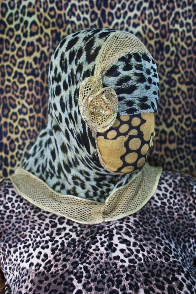 Bangladeshi woman with face covered in leopard print