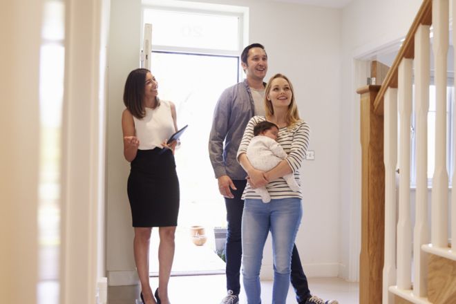 Family being shown around a house